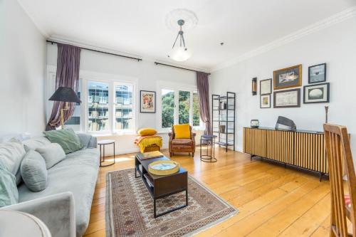 a living room with a couch and a table at Central Apt with Art Gallery Views and FREE Parking in Auckland