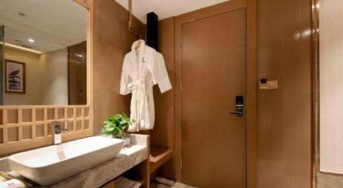a bathroom with a sink and a shower at East Queen Hotel (Xi'an Beimen Metro Station) in Xi'an