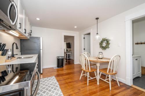 a kitchen and dining room with a table and chairs at Historic Ludlow Apt B in Ludlow