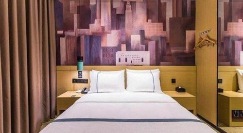 a bedroom with a large bed with a painting on the wall at City Comfort Inn Liuzhou Wuling Liutai Road in Liuzhou