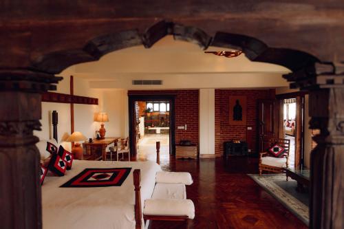 a bedroom with a bed and a living room at The Dwarika's Hotel in Kathmandu
