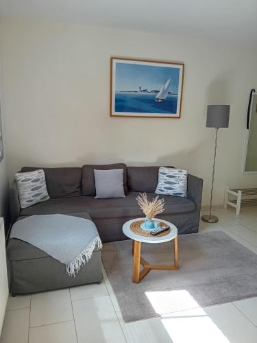 a living room with a couch and a table at Ostwind - ferienwohnungen & meer in Steffenshagen