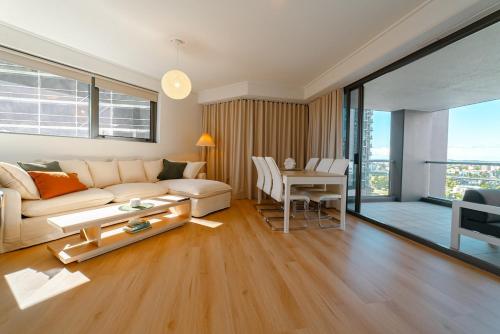a living room with a couch and a table at Lux 18th floor 2br 2bath, River view, Pool, Spa, Sauna, Gym, Wifi, in Brisbane