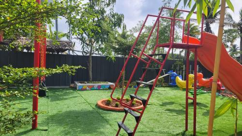 a playground with a slide in a yard at Bell Farms and Resorts in Munroe Island