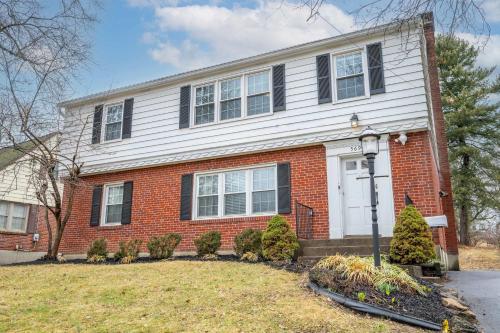 a red brick house with a white door at Kenwood Keys 1 - Cozy Stay for 6 in Cincinnati