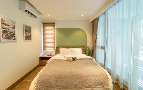 a bedroom with a bed with a large window at Crescendo Limitless Style in Hanoi