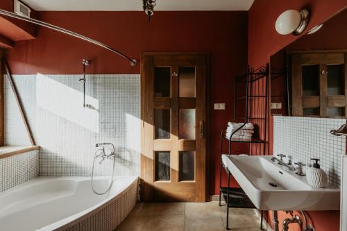 a bathroom with a white tub and a sink at Hisa Vina in Podlehnik