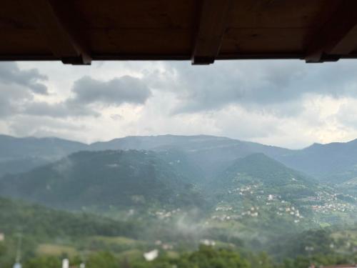 a view from a window of a mountain view at Miramontino Mountain Suite in Rota d'Imagna