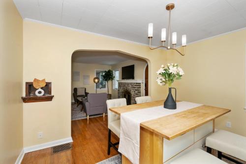a dining room and living room with a table and chairs at The Cincinnati Charm in Cincinnati
