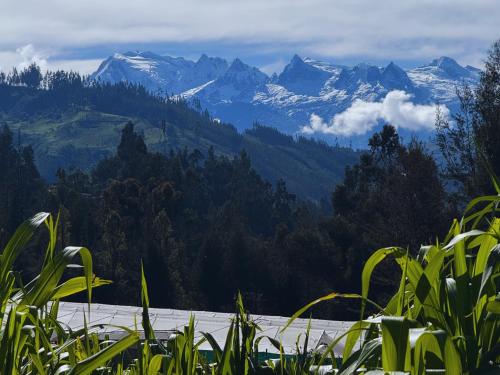 a view of a mountain range with snow covered mountains at Runaway Eco Hotel in Carhuaz