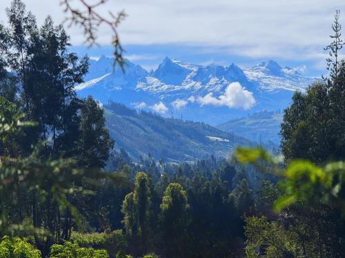 a mountain range with snow capped mountains in the distance at Runaway Eco Hotel in Carhuaz