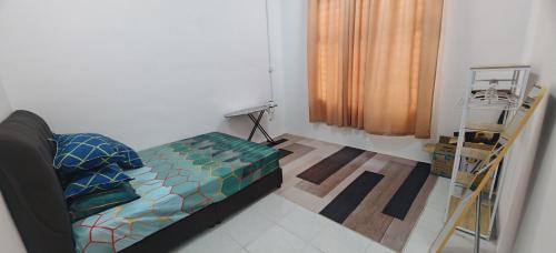 a living room with a couch and a window at ZARI Homestay Kamunting in Gua Sai