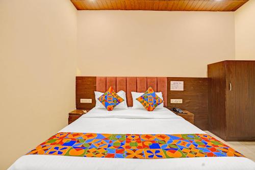 a bedroom with a bed with a colorful comforter at Via Surya Grand in Mumbai