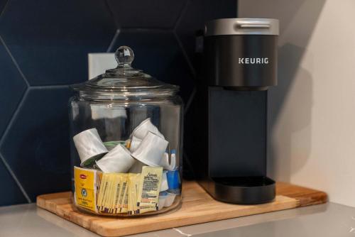 a coffee maker sitting on a wooden cutting board at Bridge Park Luxe in Dublin