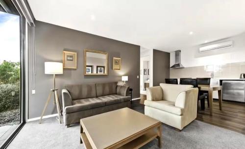 a living room with a couch and a table at Golf Apartment Heated Pool 27 in Fingal
