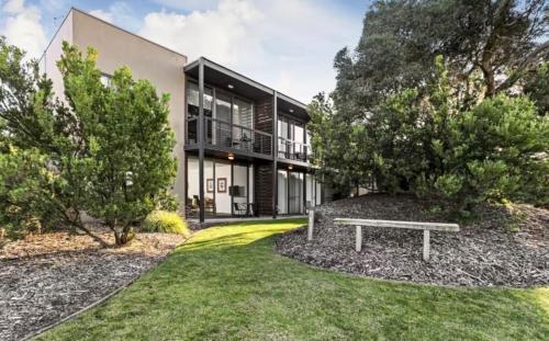 a house with a bench in front of it at Golf Apartment Heated Pool 27 in Fingal