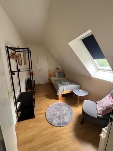 a attic room with a bed and a window at Ostwind - ferienwohnungen & meer in Steffenshagen