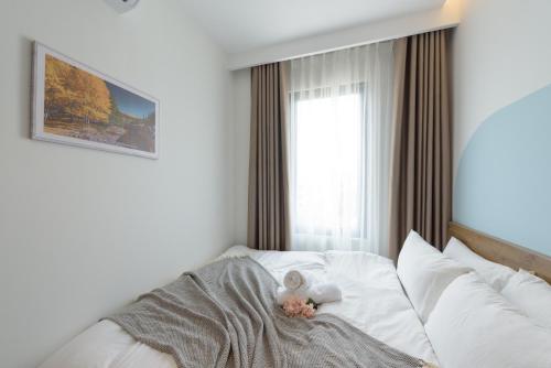 a child laying on a bed with a teddy bear at Crescendo Limitless Style in Hanoi