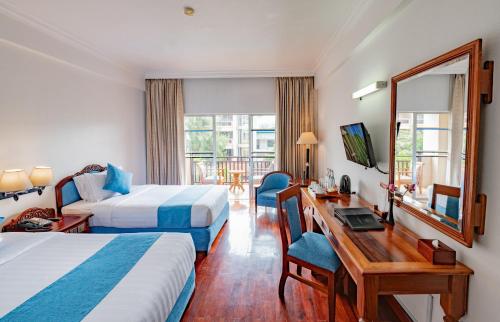 Postel nebo postele na pokoji v ubytování Hotel Somadevi Angkor Resort & Spa