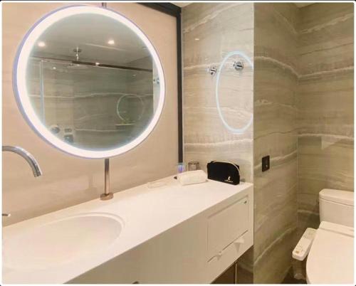a bathroom with a white sink and a mirror at OASIS AVENUE-A GDH HOTEL in Hong Kong