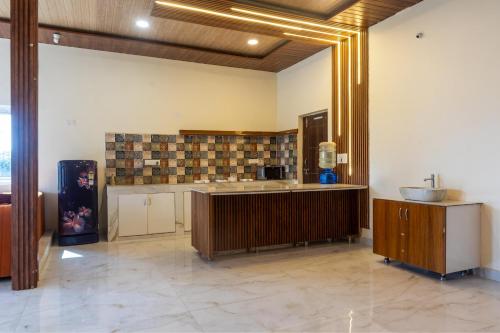 a large kitchen with a sink and a counter at Blissora Retreat Villa by StayJade-Pvt Pool-Lawn in Venkatāpur