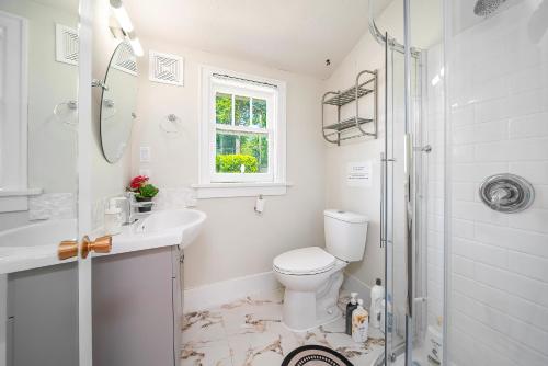 a bathroom with a toilet and a sink and a shower at Cozy four bedroom House in Vancouver West in Vancouver