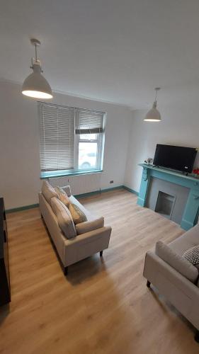 a living room with two couches and a fireplace at Florence 4 Bedroom house, sleeps 14 in Killingbeck