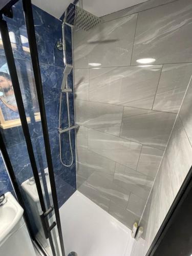 a shower with a glass door in a bathroom at Florence 4 Bedroom house, sleeps 14 in Killingbeck