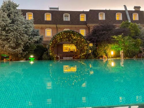a large swimming pool in front of a building at HL 309 Hotel in Tashkent