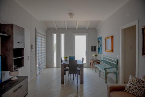 a dining room and living room with a table and chairs at Rosa Dei Venti in Calabernardo
