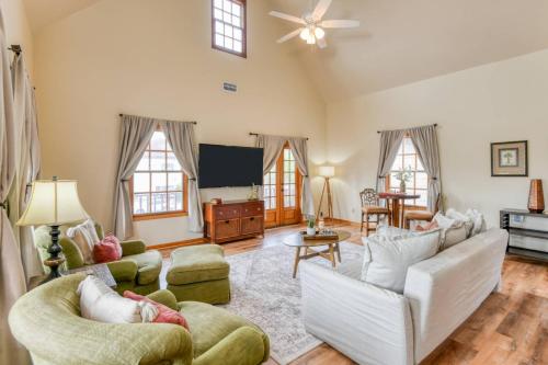 a living room with white furniture and a flat screen tv at 64 Hypolita Street in St. Augustine