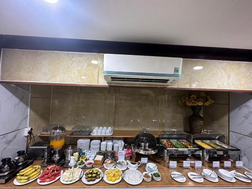 a kitchen with plates of food on a counter at DUC MINH HOTEL in Ho Chi Minh City
