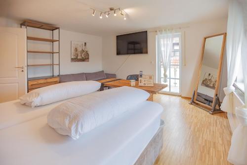 a bedroom with two beds and a living room at Ferienwohnung bei Hotel Ochsen in Ammerbuch in Ammerbuch