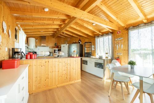 a kitchen with wooden walls and a table with chairs at Craveira Country House in Sonega