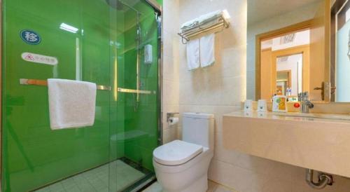 a bathroom with a toilet and a glass shower at GreenTree Inn Nantong University Industrial Expo City Express Hotel in Nantong