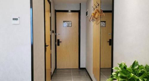a hallway with three elevators in a building at GreenTree Inn Ganzhou Gan County Bus Station in Ganzhou
