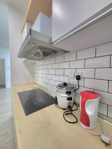 a kitchen with a counter top with a stove at Zen66 @ Roxy Serviced Apartment in Kuching