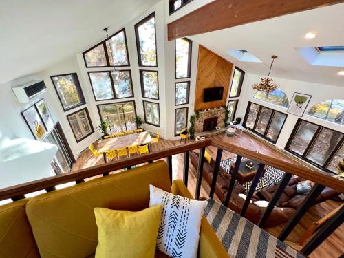 an overhead view of a living room with a yellow couch at Spacious Waterfront Mansion wHot tubPoolTable in East Stroudsburg