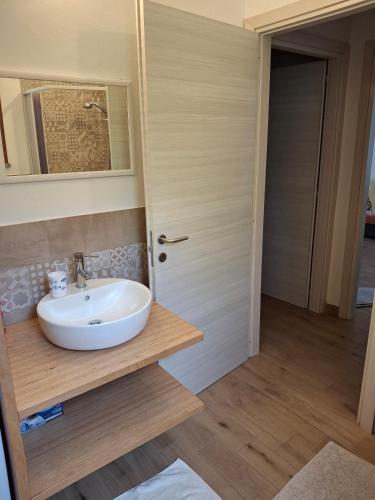 a bathroom with a white sink and a mirror at Villa Margherita in Chia