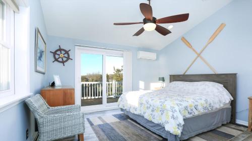 a bedroom with a bed and a ceiling fan at Sunset Retreat in North Cape May