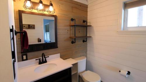 a bathroom with a sink and a mirror and a toilet at Sunset Retreat in North Cape May