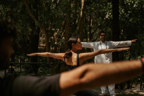 a man and a woman standing with their arms out at Dwarika's Sanctuary in Dhulikhel