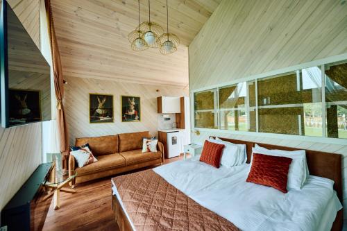 a bedroom with a bed and a couch at Сімейний Екопарк Ясногородка in Yasnogorodka