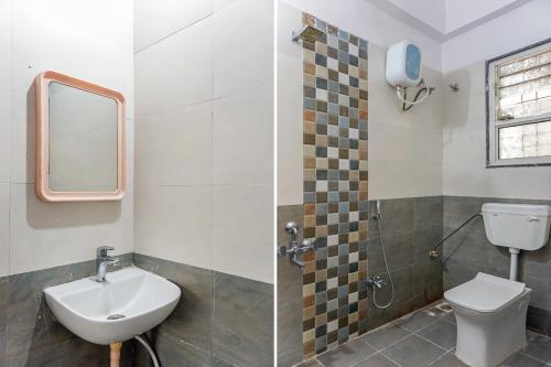 a bathroom with a sink and a toilet and a mirror at Hotel O Swagat Lodging in Khadki