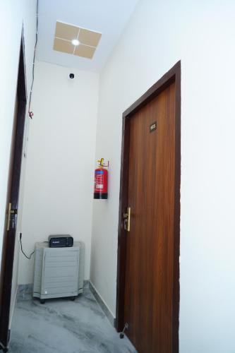 a door leading to a room with a heater and a heater at UrbanOak HOMESTAY in Haldwāni