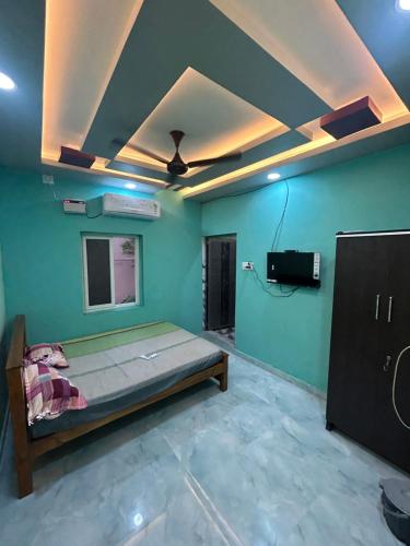 a room with a bed and a tv in it at Sri varahi homes in Rāmeswaram