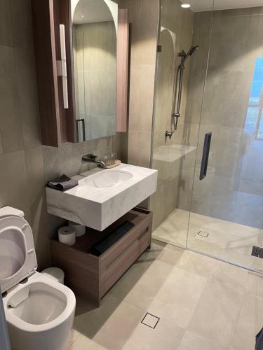 a bathroom with a toilet and a sink and a shower at Queens Wharf 50th Floor in Brisbane