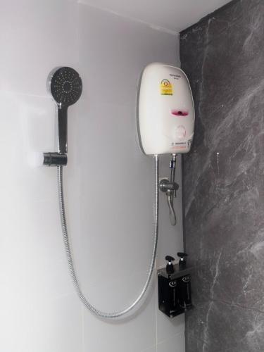 a shower in a bathroom with a shower head at KM Kwanphayao Hotel in Phayao
