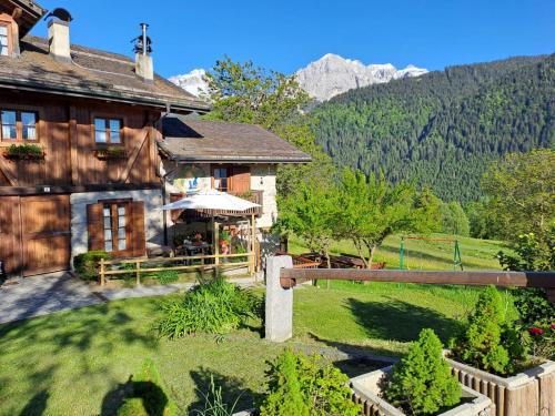 a house in the mountains with a sign in the yard at Chalet Valentina in Madonna di Campiglio
