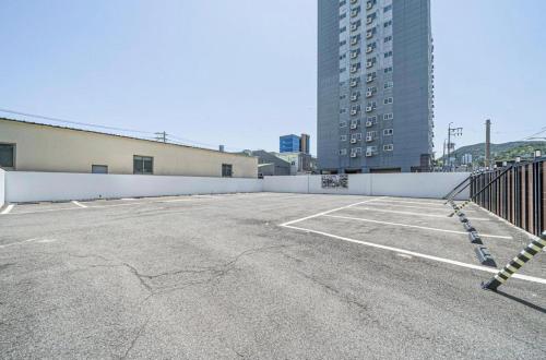 een lege parkeerplaats met een gebouw op de achtergrond bij Song-Jeong Bay Hotel in Busan